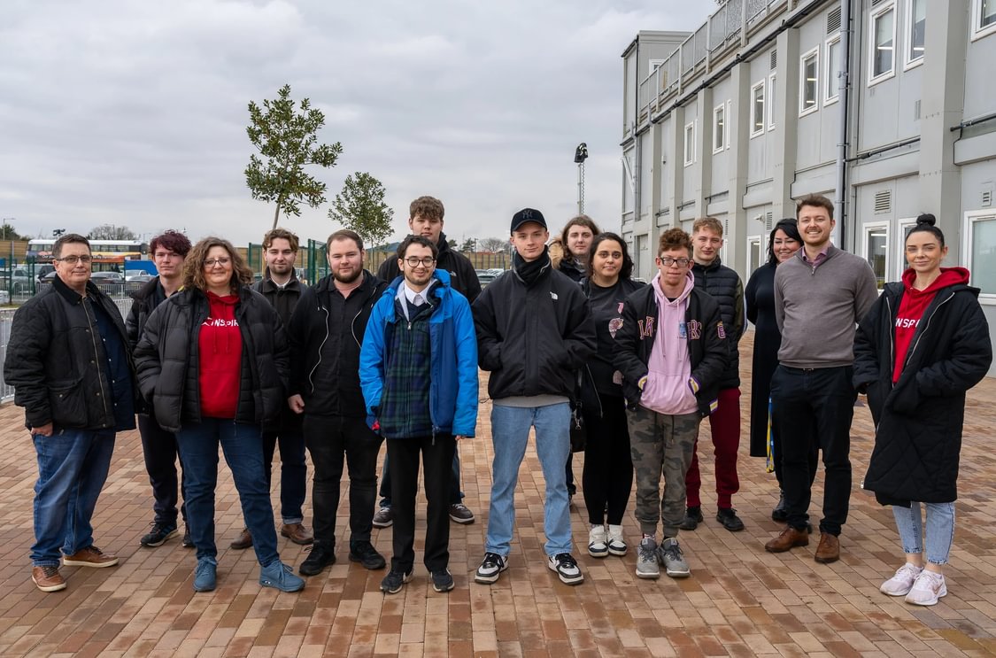 A team from Inspire visits the Sizewell C site. They are standing together posing for this pictures with representatives from Sizewell C